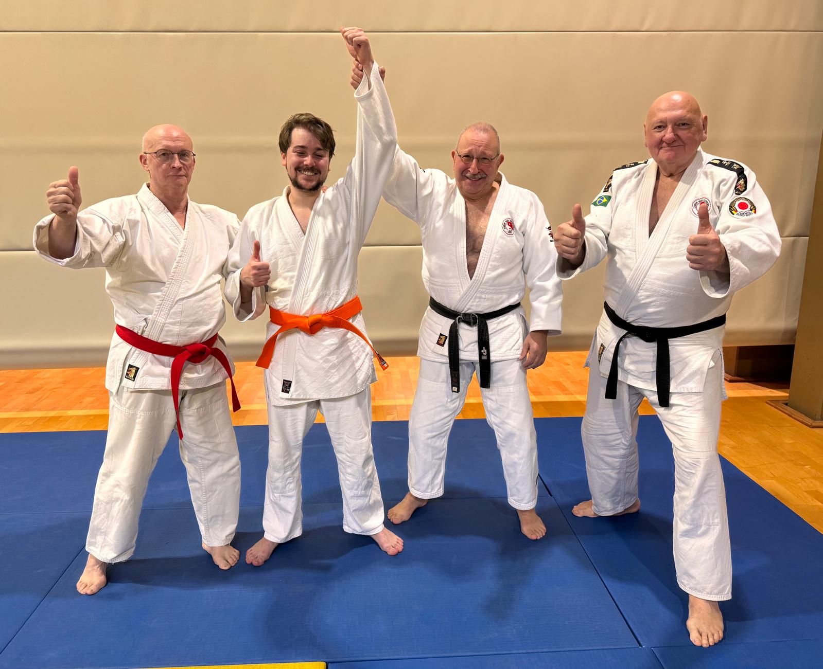 A group of men in karate uniforms

Description automatically generated