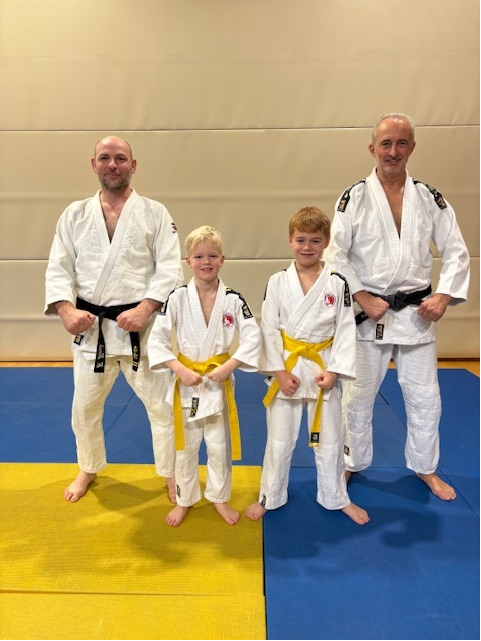 A group of people in martial arts uniforms

Description automatically generated